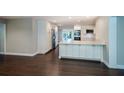 The modern kitchen is open and bright, with stainless steel appliances, white cabinetry, and wood flooring at 2325 E Harding Street, Orlando, FL 32806