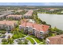 Beautifully landscaped community with a pool, lake, and attractive building exteriors at 5012 Shoreway Loop # 10107, Orlando, FL 32819