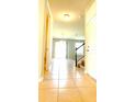 Bright foyer with tile flooring, staircase, and views of the living area at 5107 Longmeadow Park St, Orlando, FL 32811