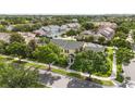 Aerial view showcasing the well-maintained townhome with a tree-lined street in a serene neighborhood at 5235 Keenes Pheasant Dr, Windermere, FL 34786