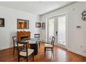 Bright dining room featuring a glass table, four chairs, wood floors and french doors to the patio at 5235 Keenes Pheasant Dr, Windermere, FL 34786