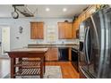The kitchen features wooden cabinets, a black refrigerator and oven, with a wooden island at 5235 Keenes Pheasant Dr, Windermere, FL 34786