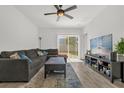 Bright living room featuring a ceiling fan, tile floors and access to outdoor patio at 555 Jett Ln, Davenport, FL 33837