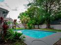 Beautiful in-ground pool surrounded by lush greenery and a white fence, perfect for relaxation at 5607 Spring Run Ave, Orlando, FL 32819