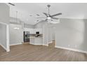 Open-concept living space featuring vaulted ceilings, stylish flooring, and modern lighting fixtures at 632 Bridge Creek Blvd, Ocoee, FL 34761