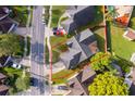 Aerial view of a property with a well-maintained lawn and mature trees, within a defined boundary at 6512 Grosvenor Ln, Orlando, FL 32835