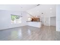 Spacious living room with tile floors, large windows, and open access to the kitchen, flooded with natural light at 6512 Grosvenor Ln, Orlando, FL 32835