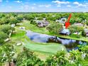 An aerial view shows the home nestled next to a pond and the golf course at 6836 Bittersweet Ln, Orlando, FL 32819