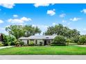 Charming single-story home featuring lush landscaping and a well-maintained front lawn at 6836 Bittersweet Ln, Orlando, FL 32819