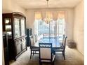 Formal dining room featuring a large table, decorative china cabinet, and a window at 8206 Gemstone Ct, Orlando, FL 32836