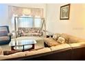 Relaxing living room with neutral colors, a swingasan, and lots of natural light at 8206 Gemstone Ct, Orlando, FL 32836