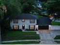 Two-story home showcasing its neat landscaping, dark roof, and proximity to surrounding trees at 1105 Appleton Ave, Orlando, FL 32806