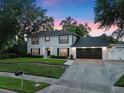 Traditional two-story home with a black roof, shuttered windows, and a neatly kept lawn at 1105 Appleton Ave, Orlando, FL 32806