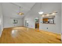 Spacious living room with hardwood floors, vaulted ceilings, and natural light, open to kitchen at 1117 Park Green Pl, Winter Park, FL 32789