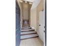 Tiled foyer featuring carpeted stairs leading to the upper level of the home at 1210 San Jacinto Cir, Sanford, FL 32771