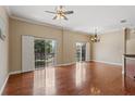 Bright living room with wood floors, ceiling fan, and sliding glass doors to the outdoor space at 1210 San Jacinto Cir, Sanford, FL 32771