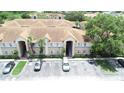 Overview of the condo complex and available parking spaces with trees at 13207 Villa Vista Dr # 205, Orlando, FL 32824