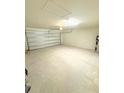 Spacious two-car garage with a white door and room for parking and storage at 1557 Venice Ln, Davenport, FL 33896