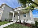 Beautiful home exterior showcasing a manicured lawn and column-lined entryway at 15579 Water Spring Blvd, Winter Garden, FL 34787