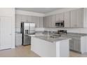 Modern kitchen boasts gray cabinets, granite countertops, and stainless steel appliances at 1580 Gardiner St, Haines City, FL 33844