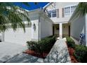 Townhome with a private entrance, manicured bushes and a one car garage at 1730 Spicebush Ct, Orlando, FL 32828