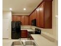 Kitchen with stainless steel appliances, wood cabinets, and tile flooring at 1730 Spicebush Ct, Orlando, FL 32828