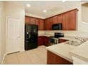 Kitchen with stainless steel appliances, wood cabinets, and tile flooring at 1730 Spicebush Ct, Orlando, FL 32828