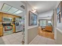 Open hallway with a view of the kitchen and living room at 210 Magnolia Rd # 214, Maitland, FL 32751