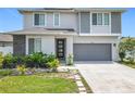Inviting two-story home with modern design, well-maintained landscaping, and a convenient two-car garage at 242 White Heron Way, St Cloud, FL 34772