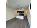 A well-lit kitchen features sleek black cabinets, a stylish island, and modern flooring throughout the open-concept space at 3213 Energy Dr, Kissimmee, FL 34747
