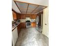 Functional kitchen featuring stainless steel appliances, ample cabinet space, and tile flooring at 34008 S Haines Creek Rd, Leesburg, FL 34788