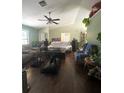 Spacious living room with hardwood floors and a vaulted ceiling, offering plenty of natural light at 34008 S Haines Creek Rd, Leesburg, FL 34788
