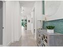 Bright hallway featuring neutral walls, and an elegant console table with stylish decor for a welcoming ambiance at 363 Miro Dr, Davenport, FL 33837
