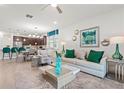 Open-concept living room featuring stylish furniture, a modern rug, and decor that seamlessly connects to the kitchen at 363 Miro Dr, Davenport, FL 33837