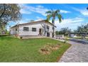 Two-story home with manicured front yard, brick driveway and walkway leading to the front entrance at 40140 Swift Rd, Eustis, FL 32736