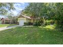 Charming single Gathering home featuring a one car garage and well maintained lawn with mature trees at 1007 Glendale St, Orlando, FL 32807
