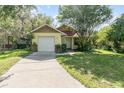 Charming single Gathering home featuring a one car garage and well maintained lawn with mature trees at 1007 Glendale St, Orlando, FL 32807