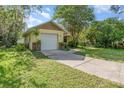 Charming single Gathering home featuring a one car garage and well maintained lawn with mature trees at 1007 Glendale St, Orlando, FL 32807