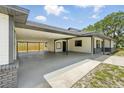 Expansive covered carport providing ample parking and featuring access to backyard at 11540 Harbor Rd, Leesburg, FL 34788
