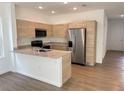 Open kitchen featuring stainless steel appliances, granite countertops, and a breakfast bar at 1205 Southstation Pl # 208, Orlando, FL 32809
