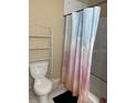 Bathroom featuring white toilet and shower curtain with cloud design at 1218 37Th St, Orlando, FL 32805