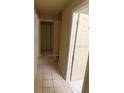 Hallway with beige colored walls and neutral tile flooring throughout the passage at 1218 37Th St, Orlando, FL 32805