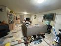 Spacious living room featuring tiled floor, entertainment center and large sectional sofa at 1218 37Th St, Orlando, FL 32805