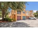 Three-story townhome with stairs leading to the second level and individual garages at 12414 Baleria Cv # 104, Orlando, FL 32837