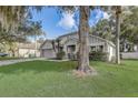 A well-maintained home on a green lawn, showcasing curb appeal with mature landscaping at 1307 Pup Fish Ln, Deland, FL 32724