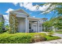 Charming home with covered porch, brick paver driveway, and beautifully manicured front yard at 14189 Larkspur Lake Dr, Winter Garden, FL 34787