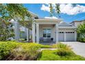 Charming home with covered porch, brick paver driveway, and beautifully manicured front yard at 14189 Larkspur Lake Dr, Winter Garden, FL 34787