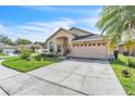 Inviting single-Gathering home boasting a well-maintained lawn, attached two-car garage, and lovely curb appeal at 14654 Lady Victoria Blvd, Orlando, FL 32826