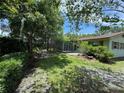 View of a lush backyard, featuring a screened-in porch at 1730 Oneco Ave, Winter Park, FL 32789