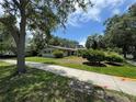 A cozy single-story home with muted colors, shutters and mature landscaping at 1730 Oneco Ave, Winter Park, FL 32789